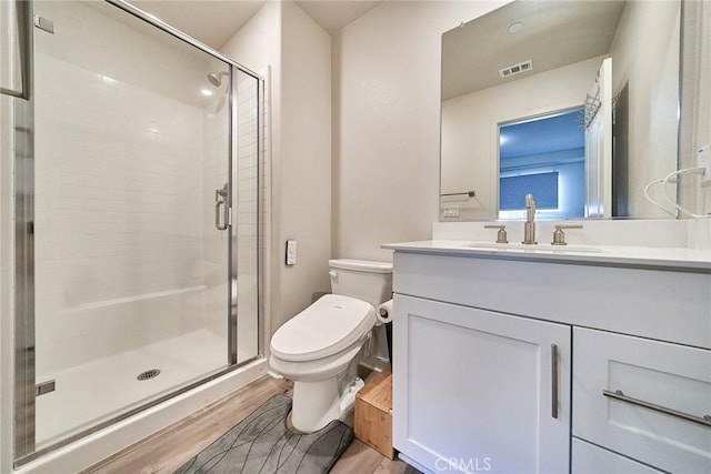 163 Dove Lndg, Covina, CA 91722 - bathroom featuring wood finished floors, toilet, a stall shower, and vanity