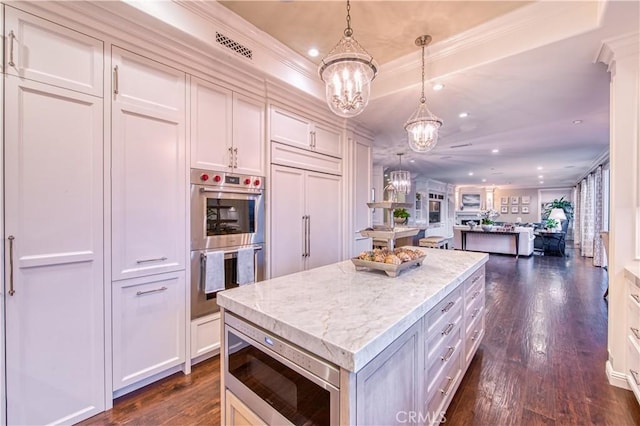 32 Panorama, Coto De Caza, CA 92679 - kitchen featuring ornamental molding, a kitchen island, dark wood-style floors, a chandelier, and appliances with stainless steel finishes