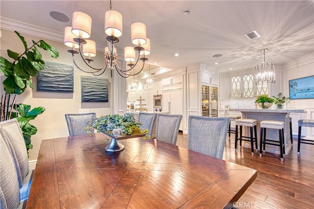 32 Panorama, Coto De Caza, CA 92679 - dining room featuring visible vents, crown molding, wood finished floors, an inviting chandelier, and recessed lighting