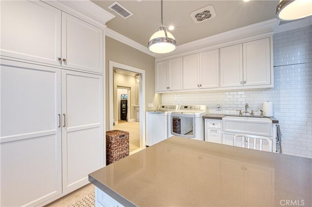 32 Panorama, Coto De Caza, CA 92679 - interior space featuring a sink, visible vents, washing machine and dryer, and ornamental molding
