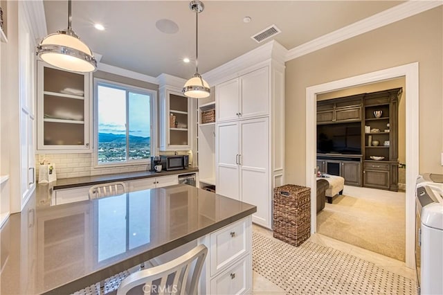 32 Panorama, Coto De Caza, CA 92679 - kitchen featuring visible vents, dark countertops, white cabinets, glass insert cabinets, and ornamental molding