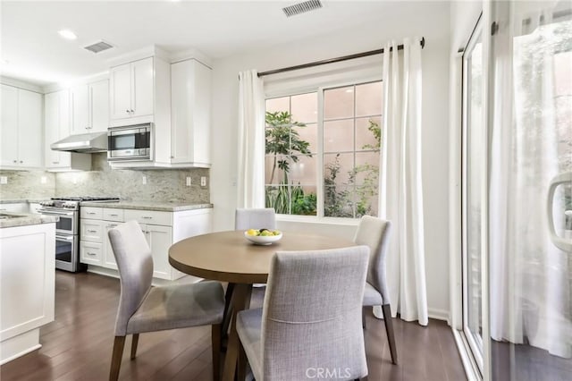 dining space featuring dark wood finished floors and recessed lighting