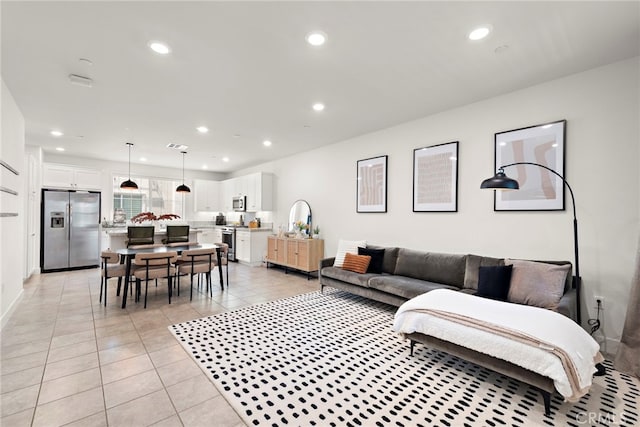 living room with recessed lighting, baseboards, and light tile patterned flooring