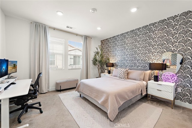 carpeted bedroom with recessed lighting, wallpapered walls, visible vents, and an accent wall