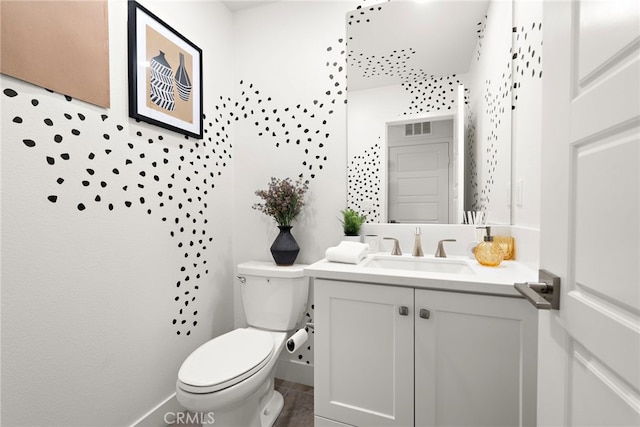 bathroom featuring vanity, tile patterned flooring, toilet, and visible vents