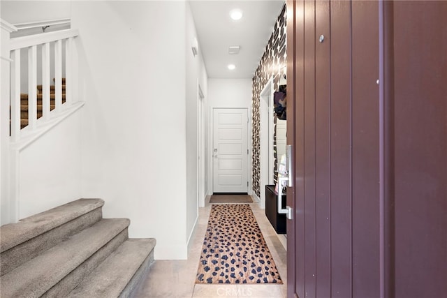 hallway featuring recessed lighting and stairs