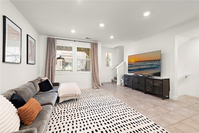 living area featuring recessed lighting, baseboards, light tile patterned floors, and stairway
