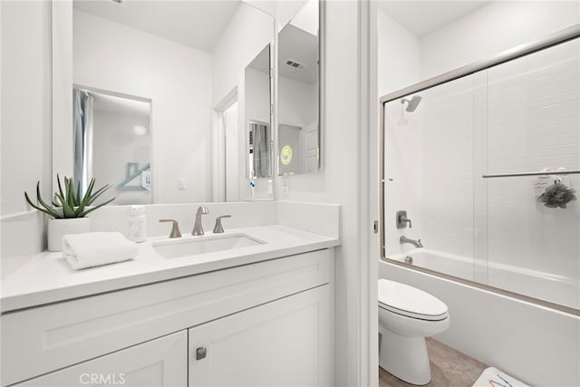 full bath featuring vanity, bath / shower combo with glass door, toilet, and visible vents