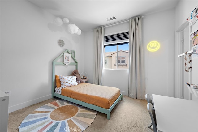 carpeted bedroom featuring baseboards and visible vents