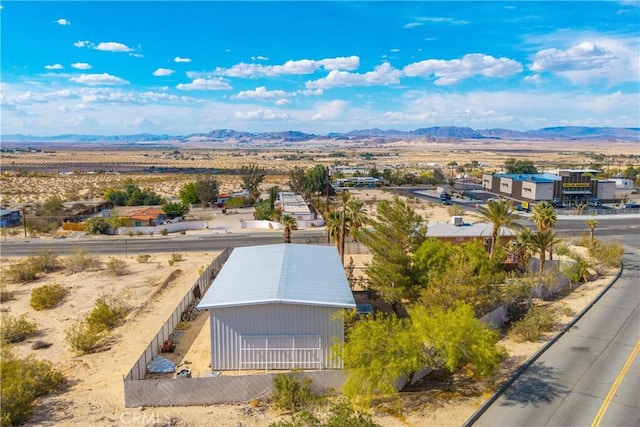 birds eye view of property with a desert view and a mountain view