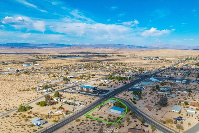 drone / aerial view with a desert view, a mountain view, and a rural view