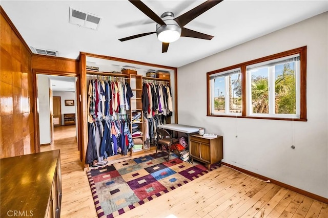 bedroom featuring visible vents, wood-type flooring, baseboards, and a closet
