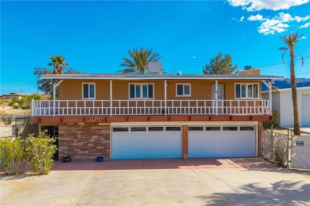 front of property with an attached garage, stucco siding, concrete driveway, and a chimney