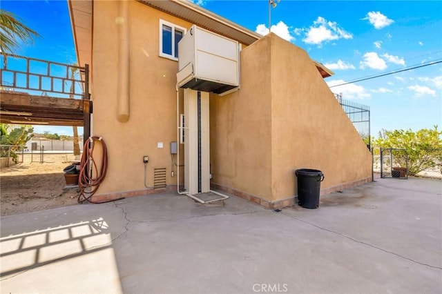 back of house featuring a patio, a gate, stucco siding, and fence