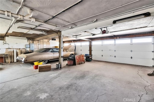 garage featuring a garage door opener and electric panel