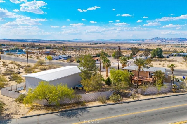birds eye view of property with view of desert and a mountain view