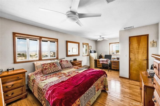 bedroom featuring a ceiling fan, light wood-type flooring, and visible vents