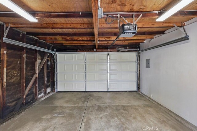 8313 Washington Ave, Whittier, CA 90602 - garage with a garage door opener, electric panel, and baseboards