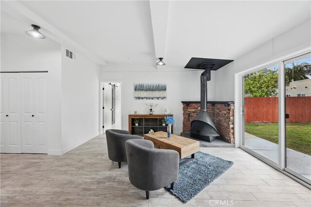 8313 Washington Ave, Whittier, CA 90602 - living room featuring a wood stove and wood finished floors