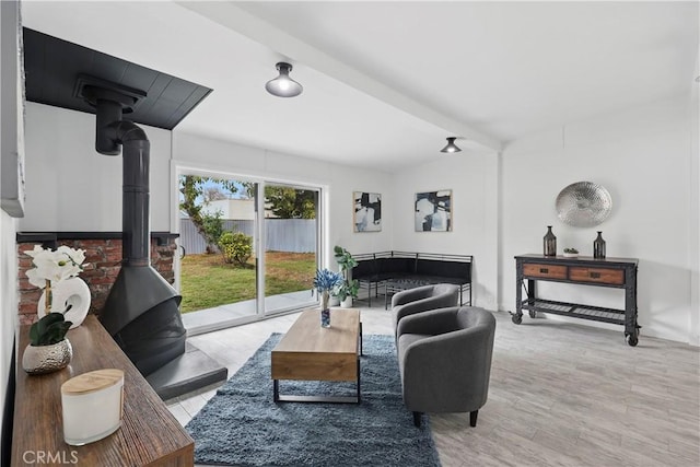 living room featuring wood finished floors and a wood stove