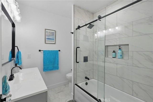 bathroom featuring toilet, baseboards, bath / shower combo with glass door, and vanity
