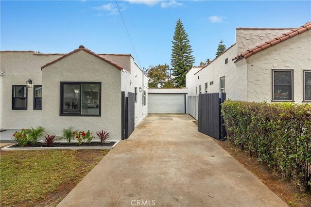 view of side of home featuring fence, stucco siding, and a tile roof