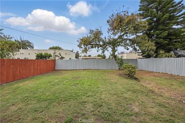 view of yard with a fenced backyard