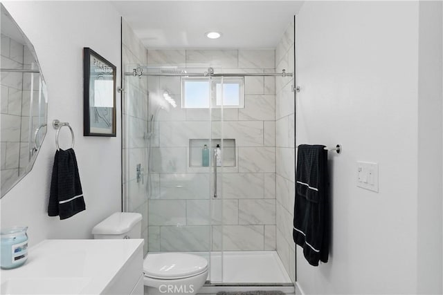 full bath with vanity, toilet, and a shower stall