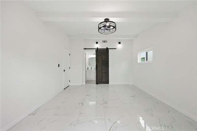 8313 Washington Ave, Whittier, CA 90602 - spare room with a barn door, beam ceiling, baseboards, and light marble finish flooring