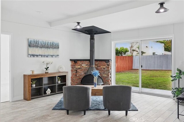 8313 Washington Ave, Whittier, CA 90602 - living room with a wood stove, wood finished floors, and beam ceiling