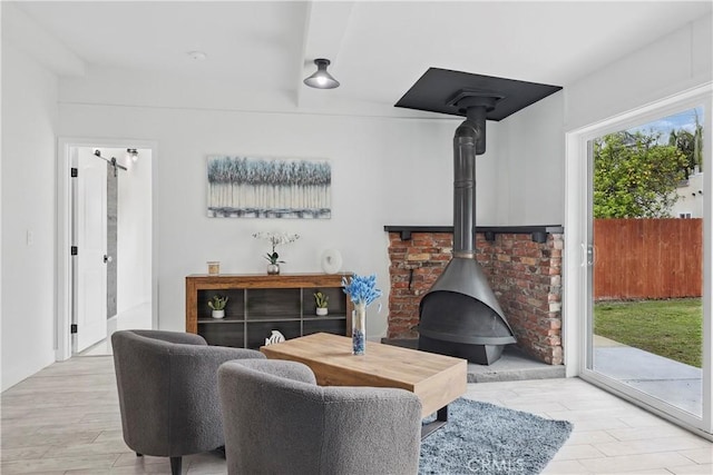 living room featuring wood finished floors and a wood stove