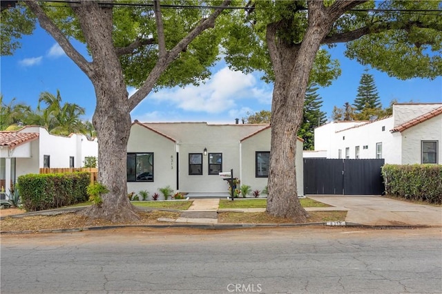 view of front of property with fence and stucco siding