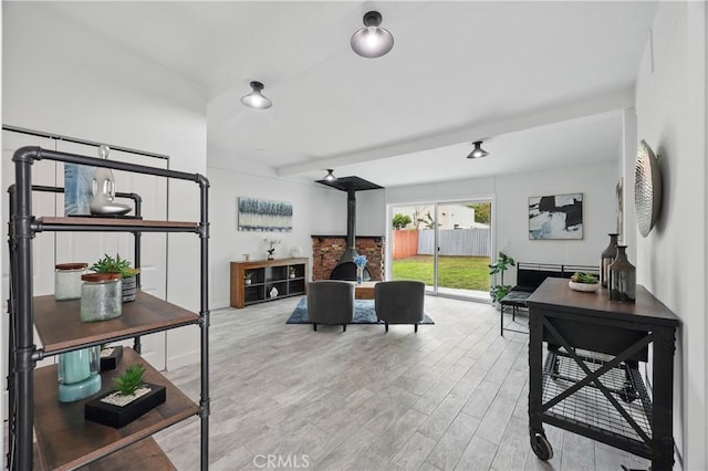 living room featuring a wood stove and wood finished floors