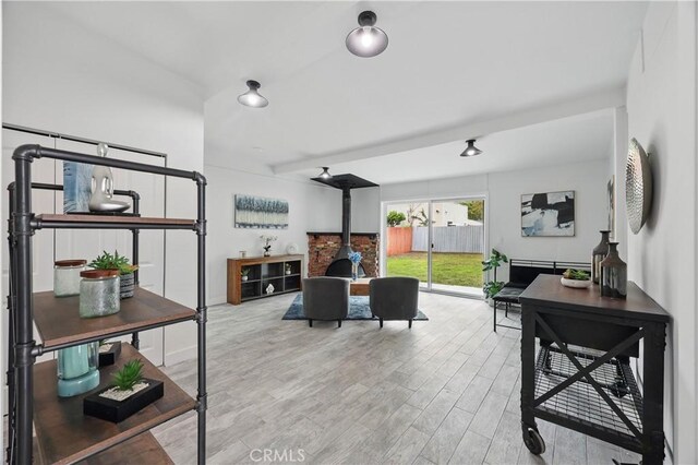 8313 Washington Ave, Whittier, CA 90602 - living area featuring wood finished floors and a wood stove