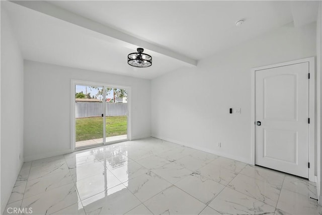 spare room featuring baseboards, beam ceiling, and marble finish floor
