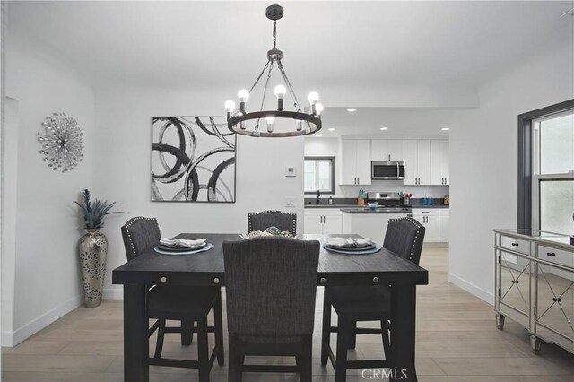 8313 Washington Ave, Whittier, CA 90602 - dining room featuring a chandelier, light wood-style floors, baseboards, plenty of natural light, and recessed lighting