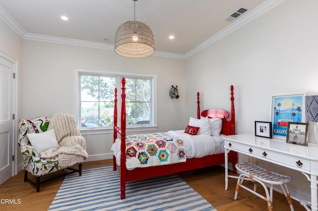 bedroom with recessed lighting, visible vents, ornamental molding, and wood finished floors