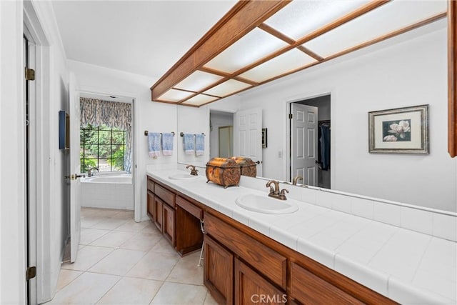 full bath featuring a sink, tile patterned floors, a garden tub, and double vanity