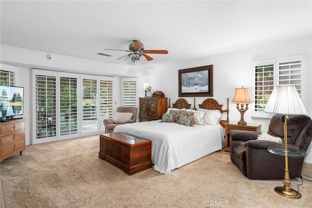 carpeted bedroom featuring visible vents, ceiling fan, multiple windows, and access to exterior