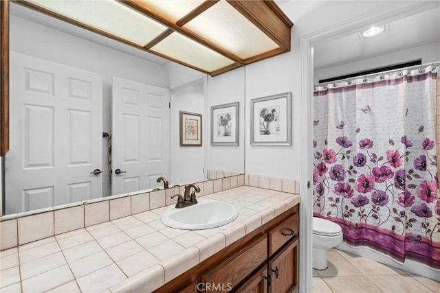 bathroom with vanity, tile patterned floors, shower / bath combo, and toilet