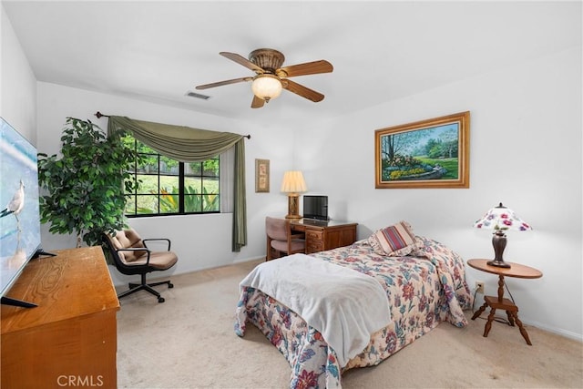 carpeted bedroom with a ceiling fan and visible vents