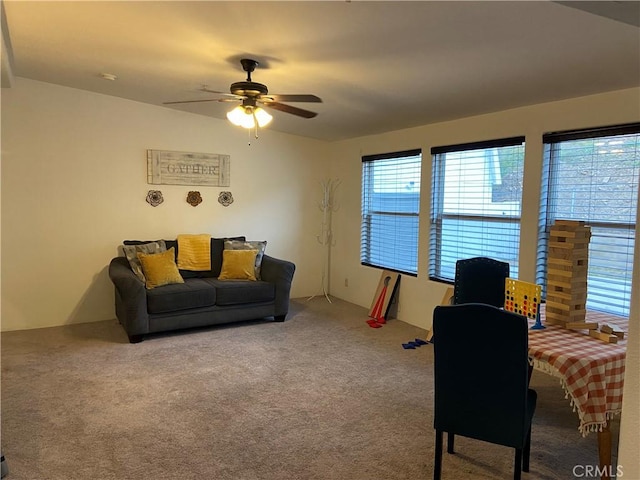 living room featuring a ceiling fan and carpet flooring