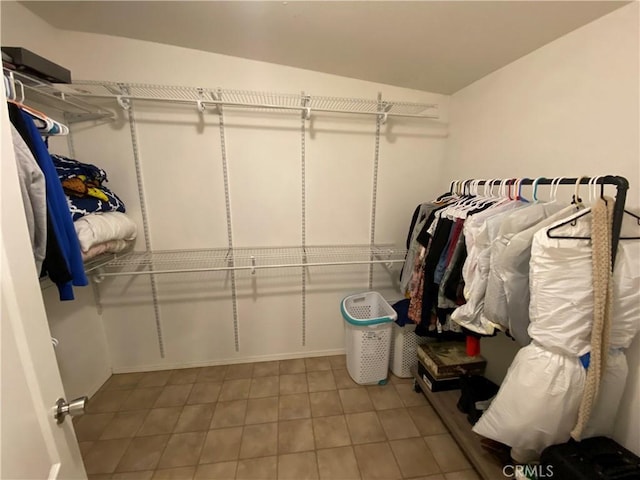 spacious closet featuring tile patterned floors and vaulted ceiling