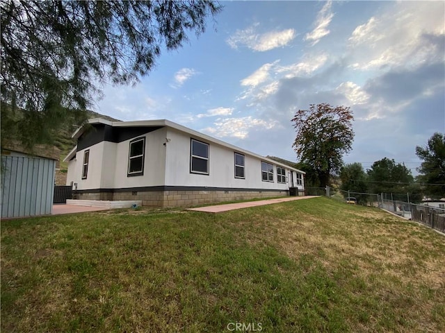 rear view of property featuring fence, a patio, a yard, and central AC unit