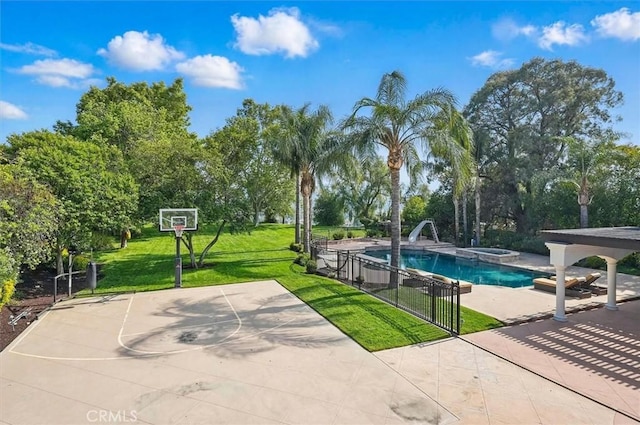 view of swimming pool with a water slide, view of scattered trees, community basketball court, and a pool with connected hot tub