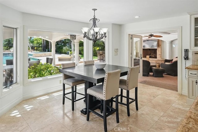 dining space featuring plenty of natural light, a ceiling fan, a chandelier, recessed lighting, and baseboards