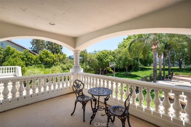 balcony with view of wooded area
