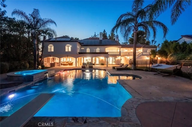 view of swimming pool with a patio, a pool with connected hot tub, and outdoor lounge area