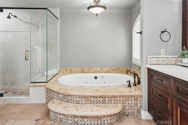 full bathroom with a shower stall, a whirlpool tub, vanity, and tile patterned flooring