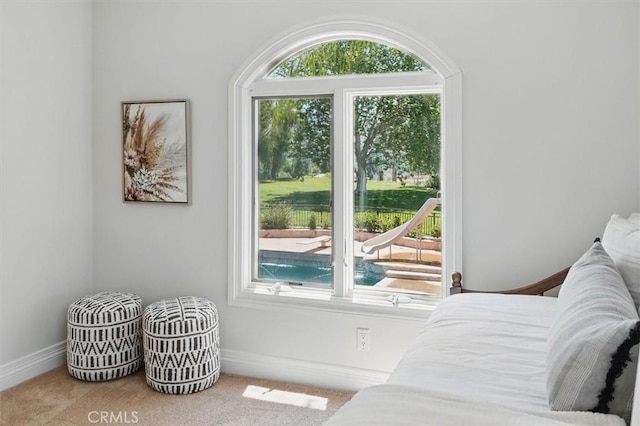 bedroom featuring carpet and baseboards